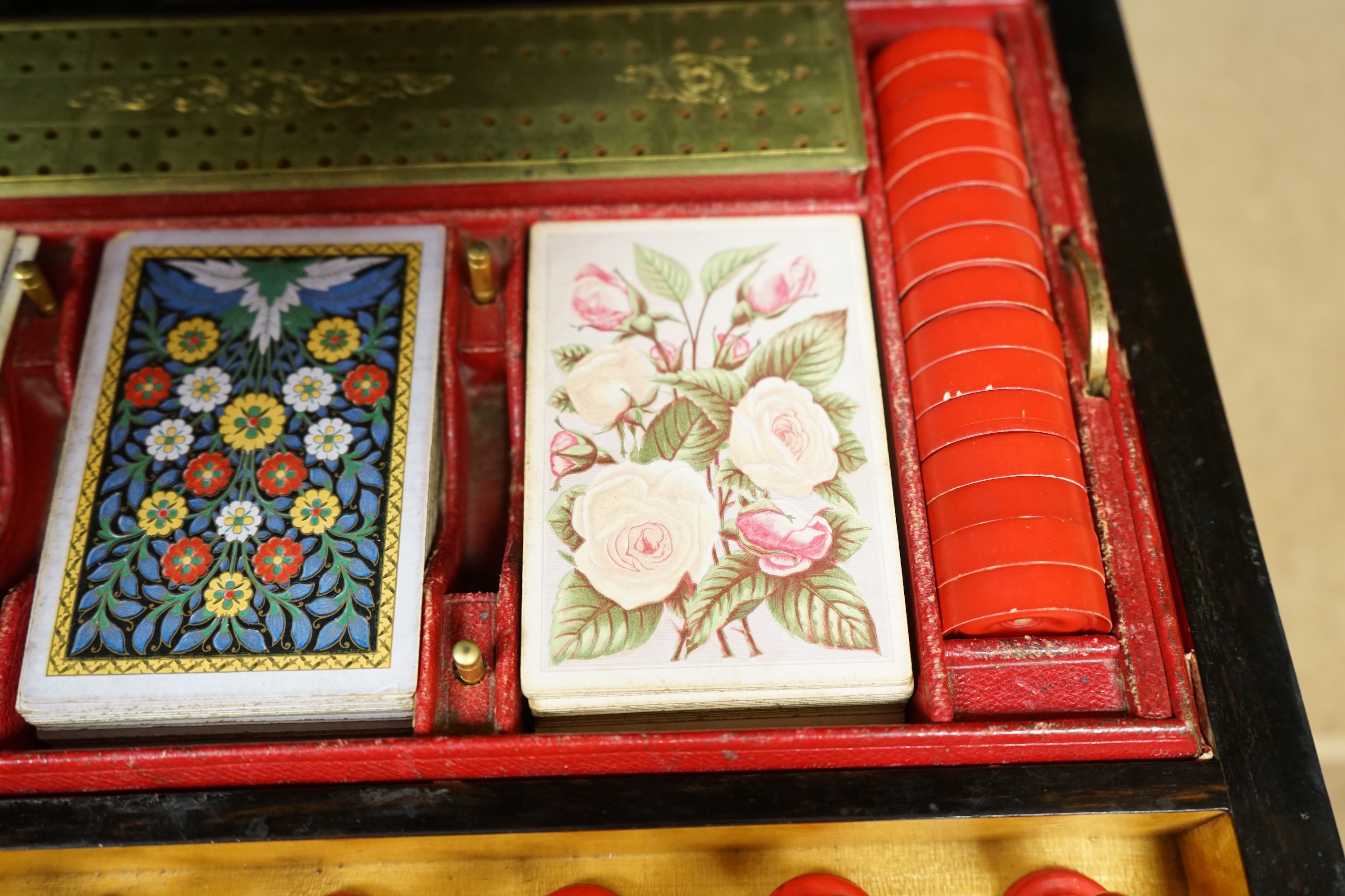 A Victorian coromandel games box with accessories, ivory chess pieces and counters, box 36cm wide x 19cm high. Condition - red interior leather worn and torn in places and box scratched, minor losses to chess pieces. CIT